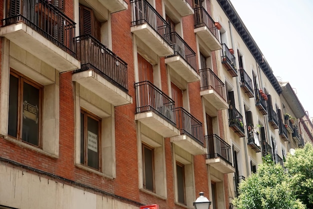 Street view looking up at apartment block in city Madrid. Traditional architecture of Madrid, Spain