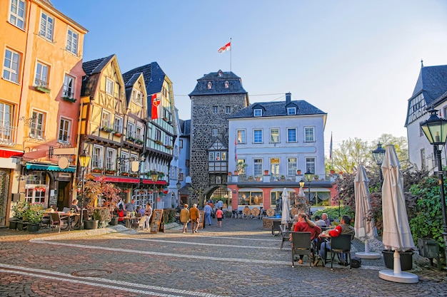 Street view on Rhientor City Gate on Burgplatz in Linz am Rhein in Rhineland-Palatinate in Germany. Square in the City center. Tourists around.