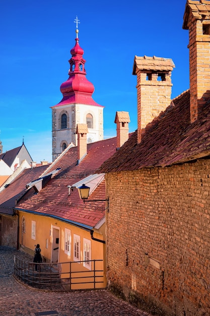 Street view with Ptuj City Tower in the center of old town in Slovenia. Building architecture in Slovenija. Travel