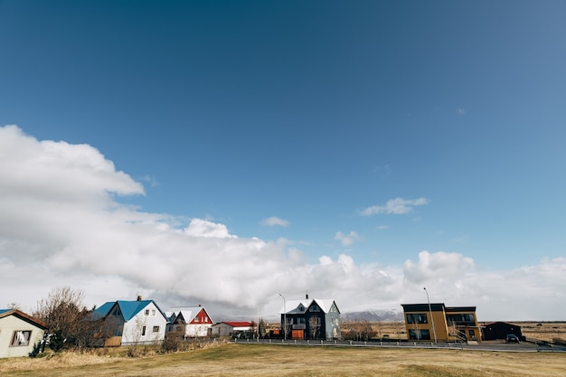 A street with apartment buildings in a sleeping area in iceland where icelanders live against a blue