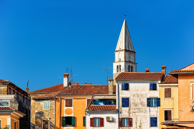 Street with Church of Holy Maurus in Izola, Slovenia