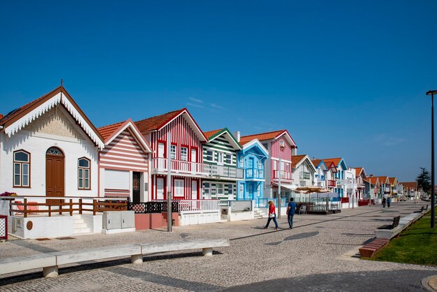 Street with colorful striped houses typical of Costa Nova Aveiro Portugal