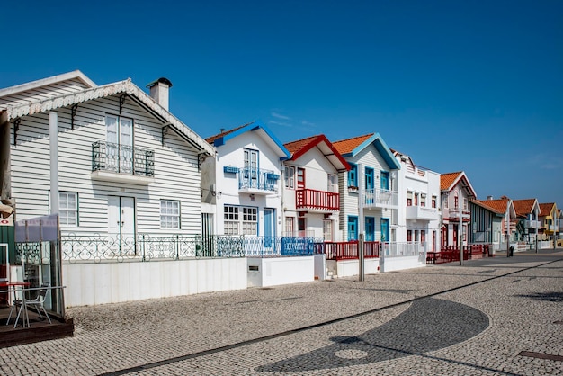 Street with colorful striped houses typical of Costa Nova Aveiro Portugal