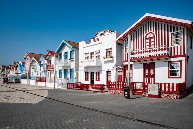 Street with colorful striped houses typical of Costa Nova Aveiro Portugal