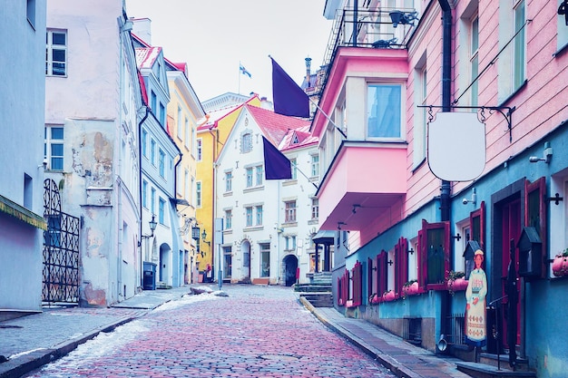 Street with flags in the Old city in Tallinn, Estonia in winter.