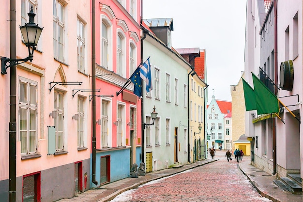 Street with flags in the Old city of Tallinn, Estonia in winter.