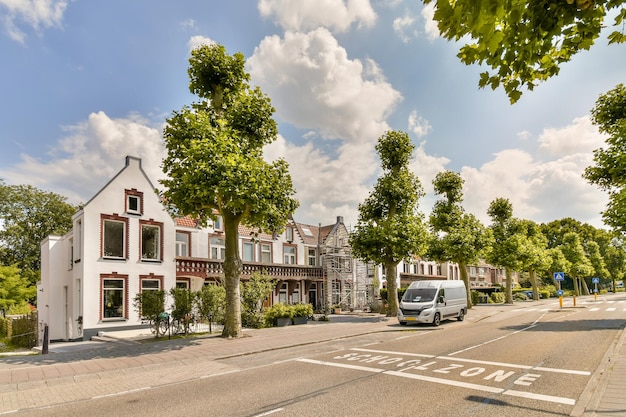 A street with houses and a van driving down it