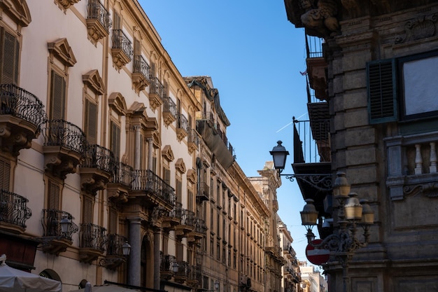 A street with a lot of buildings and a red and white sign