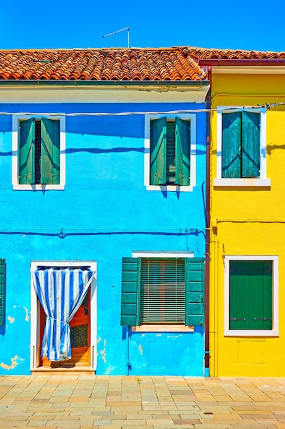 Street with multicolored houses in Burano, Venice, Italy