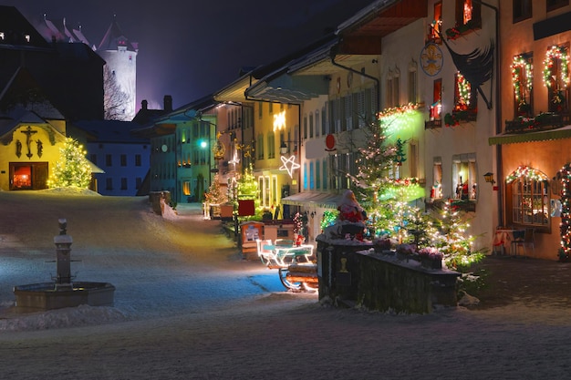 Streets of medieval town of Gruyeres (district of Gruyere, Fribourg canton, Switzerland) decorated for Christmas