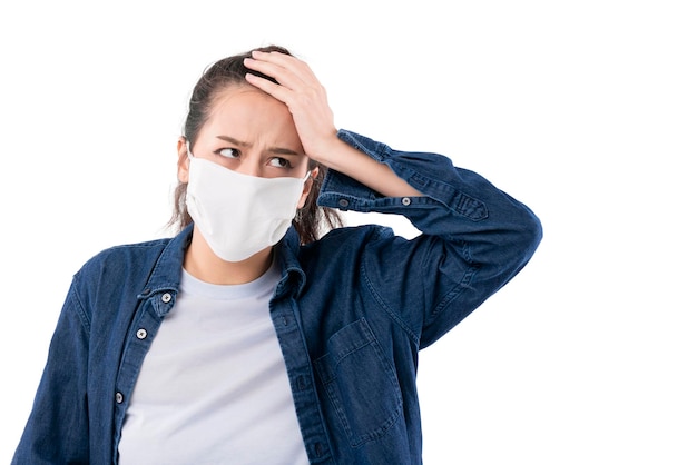 Stress confuse asian female wearing mask to protect outbreak from coronavirus or covid19 outbreak portrait hand touch her head health ideas concept asian female headache and migraine feeling isolate