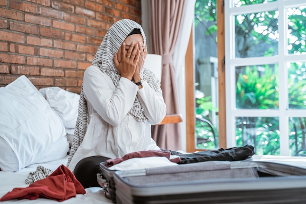 Stress muslim woman packing her stuff