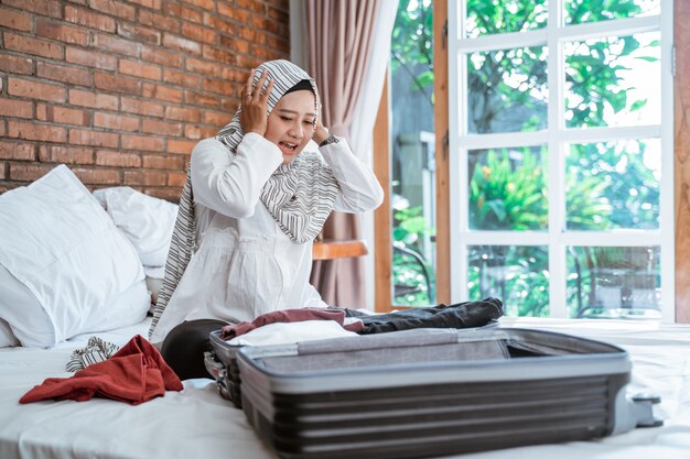 Stress muslim woman packing her stuff