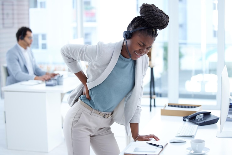 Photo stress tired and call center woman with back pain burnout or health problem in customer care or sales black female crm or support agent or consultant with injury backache or stretching muscle