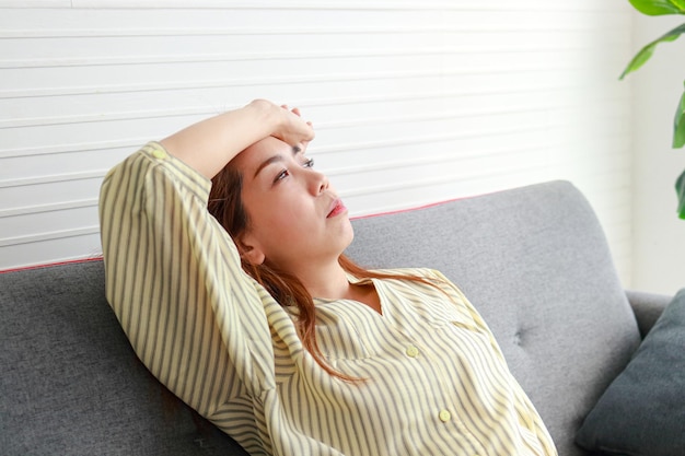 Stressed Asian woman laying her hands on her forehead Worried about problems Depression concept cumulative stress disorder