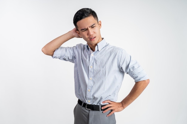 Stressed asian young young man holding head