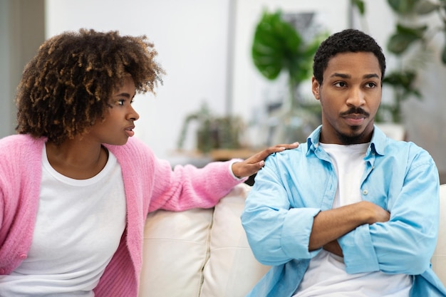 Stressed black woman saying sorry after quarrel to frustrated husband