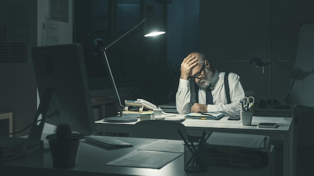 Stressed business executive working overtime