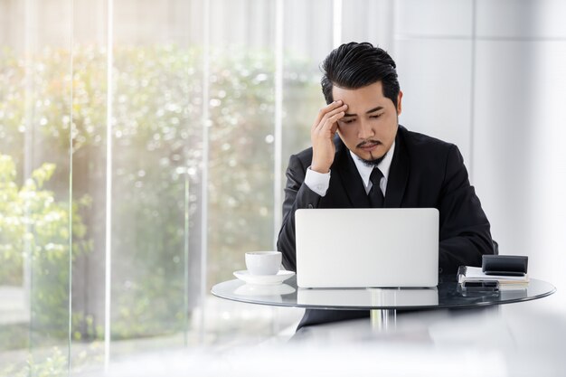 Stressed business man using laptop and working problem 