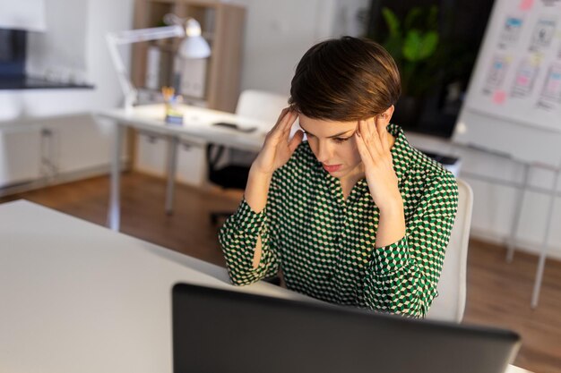 stressed businesswoman at night office