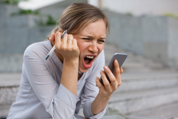 Stressed businesswoman recording audio message