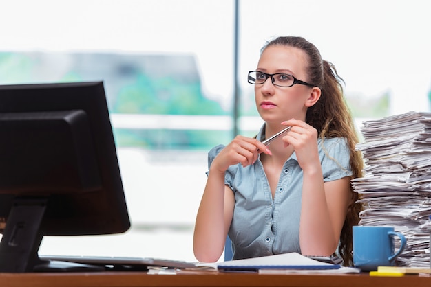 Stressed businesswoman with stack of papers