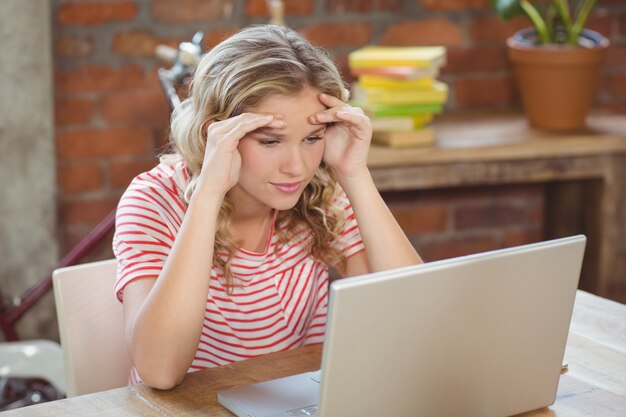 Stressed businesswoman working in creative office