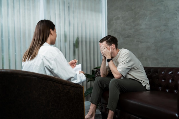 Stressed and depressed patient seeking help from psychiatrist with mental illness and depression in office during mental therapy session Mental health treatment and medical care concept Unveiling