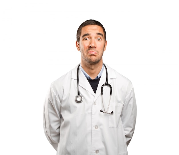 Stressed doctor against white background