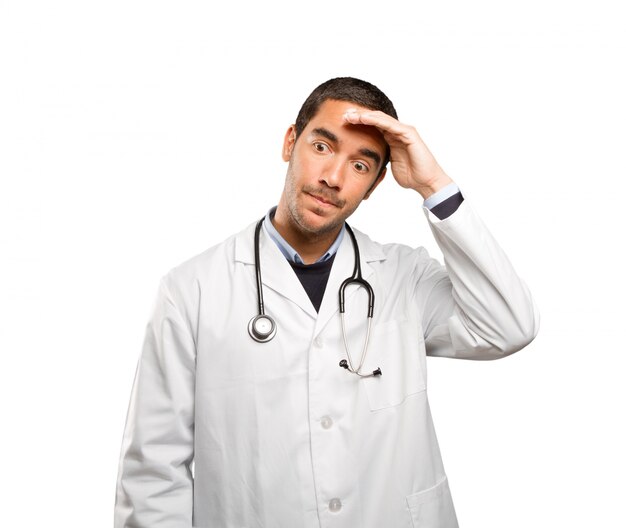 Stressed doctor against white background