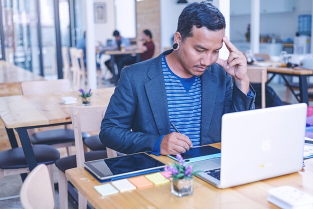 Stressed guy of business man leaning on a desk. Human face expression emotions. 