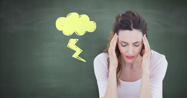 Stressed headache woman with lightning cloud doodle on blackboard