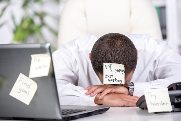 Stressed man is looking online for a job.