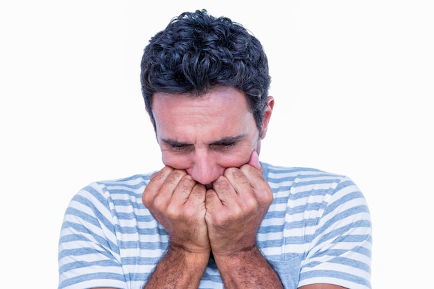 Stressed man with hands in front of his mouth