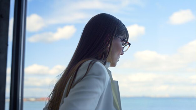 Stressed manager looking window in office closeup Depressed woman talking alone