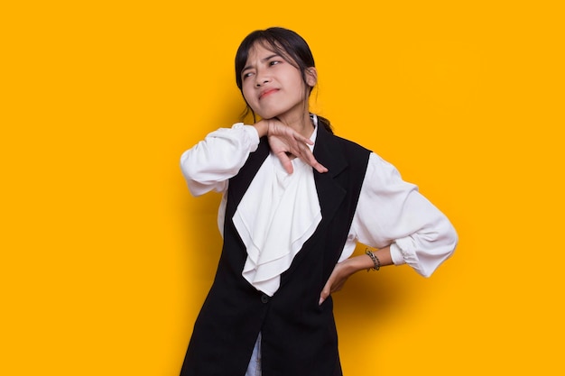 stressed sick asian woman tired with headache isolated on yellow background