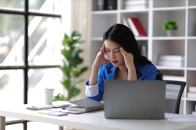 Stressed and sick businesswoman working in the office