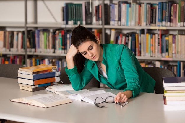 Stressed Student Of High School Sitting At The Library Desk  Shallow Depth Of Field