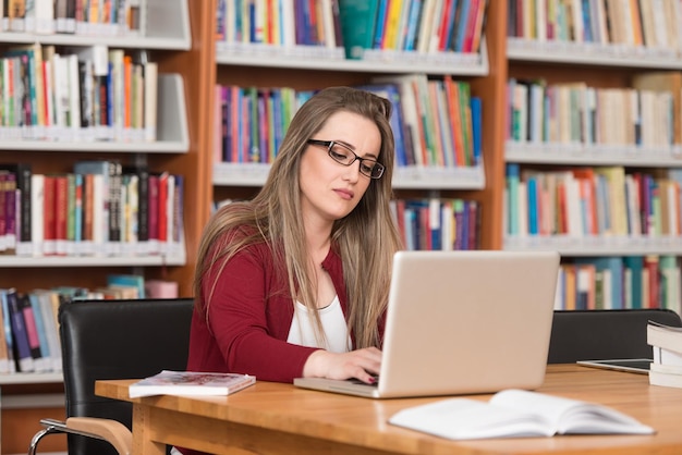 Stressed Student Of High School Sitting At The Library Desk  Shallow Depth Of Field