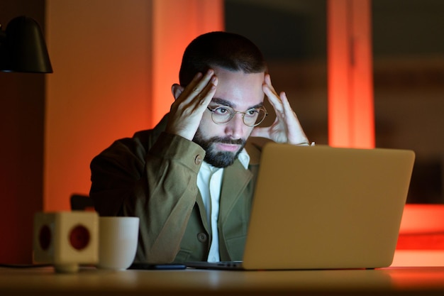 Stressed tired businessman work late at night in office try to find solution to project problem