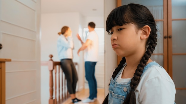 Stressed and unhappy young girl hide from domestic violence at home Synchronos