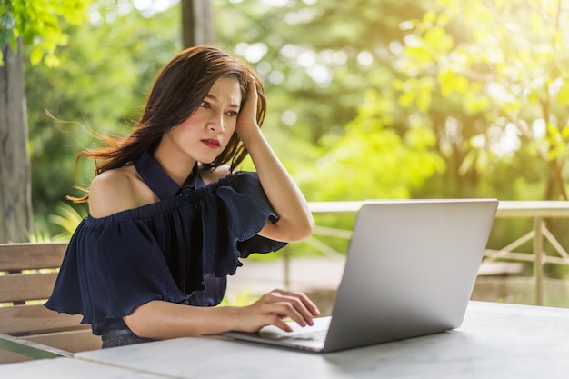 Stressed woman using laptop computer