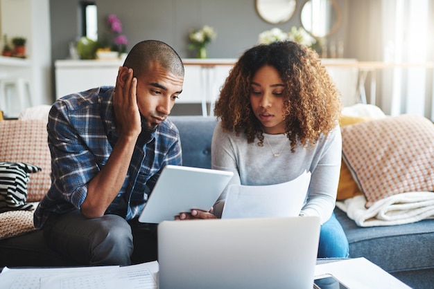 Stressed worried and anxious couple doing finances budget and internet banking Upset couple looking at savings and online investment Man and woman struggling with debt loan and bond payment