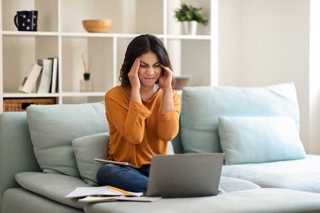 Stressed Young Arab Female Student Study With Laptop At Home