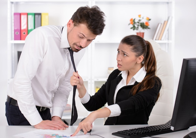 Stressed young business woman shouting at his secretary.