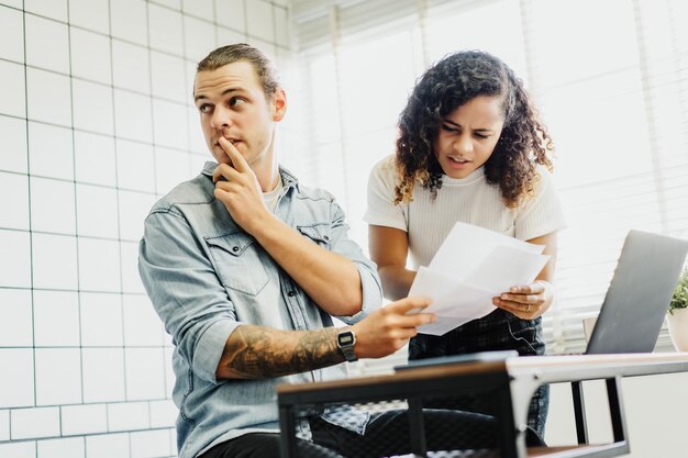 Stressed young couple managing finances problems not able to pay off their loan because of many debt