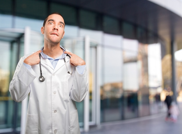 Stressed young doctor with a gesture of ansiety