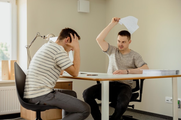 Stressed young office employee has problems at work boss is\
angry risk of dismissal mental health overwhelmed by working\
deadline stress mistake at work negative emotions