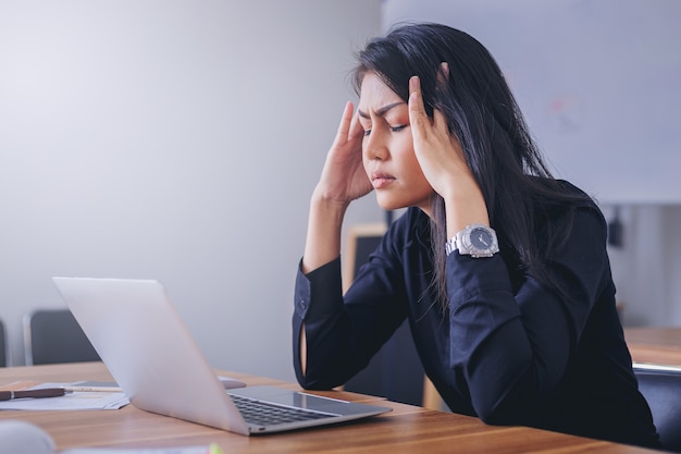 Stressful businesswoman working in office tired and bored.