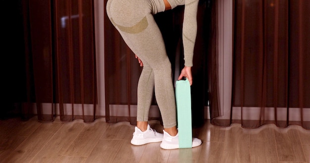 Stretch more. sporty woman in sportswear using elastic band for doing stretching exercises.